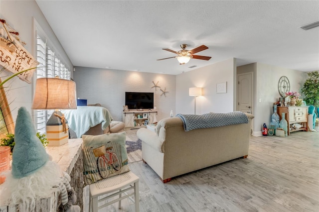 114 Ocean Aire Ter N, Ormond Beach, FL 32176 - living area featuring ceiling fan, light wood-style flooring, and a textured ceiling