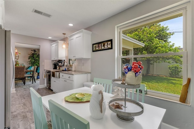 114 Ocean Aire Ter N, Ormond Beach, FL 32176 - dining area featuring light wood-type flooring, recessed lighting, and baseboards