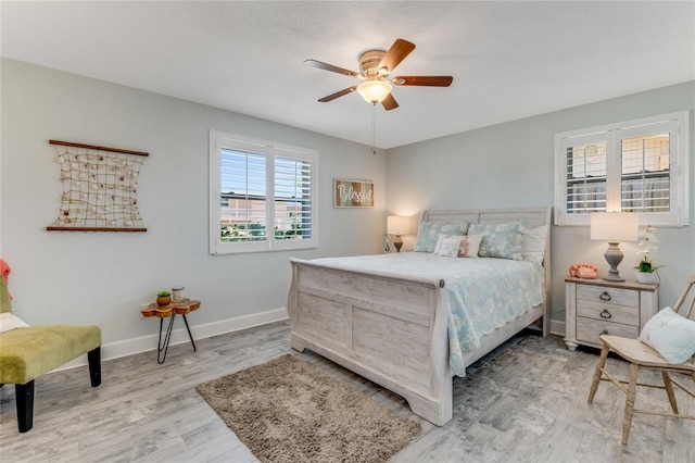 114 Ocean Aire Ter N, Ormond Beach, FL 32176 - bedroom featuring light wood-style flooring, baseboards, and ceiling fan
