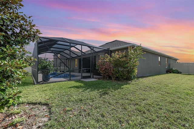 684 Stonebriar Dr SE, Palm Bay, FL 32909 - back of house at dusk with a patio area, an outdoor pool, and glass enclosure