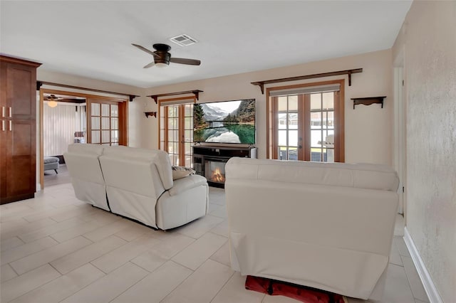 953 Tulip St, Deltona, FL 32725 - living area with ceiling fan, french doors, plenty of natural light, and a glass covered fireplace