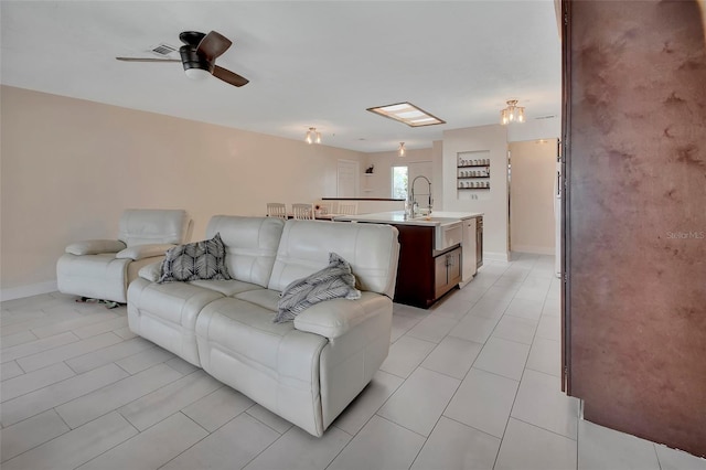 953 Tulip St, Deltona, FL 32725 - living room with light tile patterned floors, a ceiling fan, and baseboards