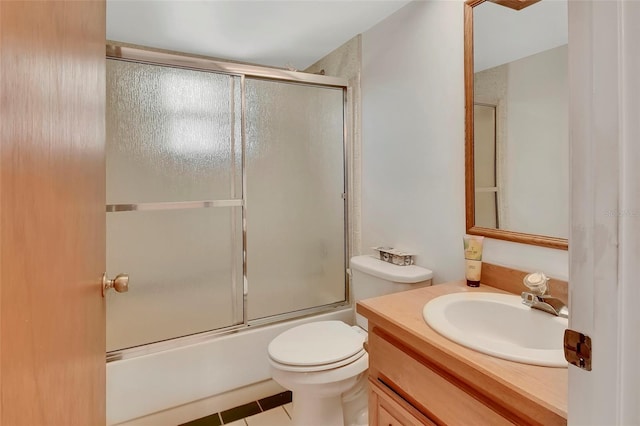 953 Tulip St, Deltona, FL 32725 - full bath with tile patterned floors, vanity, toilet, and enclosed tub / shower combo