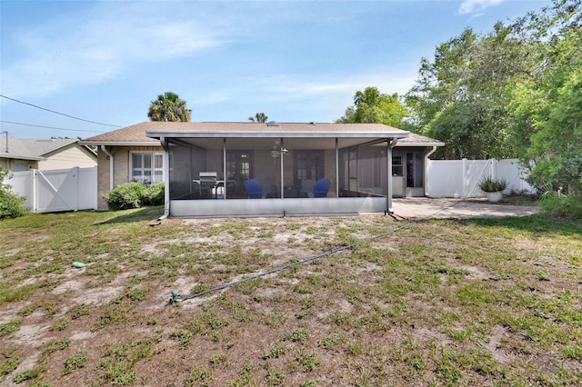 953 Tulip St, Deltona, FL 32725 - rear view of house featuring a sunroom, a gate, and a patio area