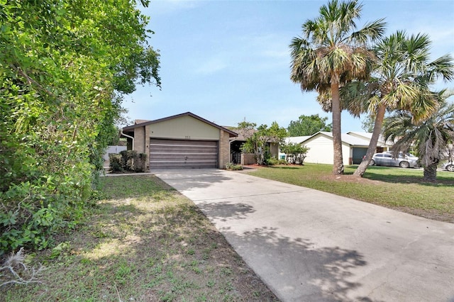 953 Tulip St, Deltona, FL 32725 - ranch-style home with concrete driveway, a garage, and a front lawn