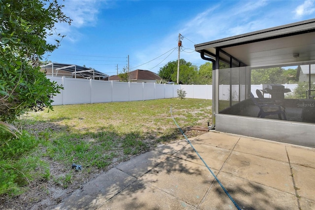 953 Tulip St, Deltona, FL 32725 - view of yard featuring a sunroom and a patio area