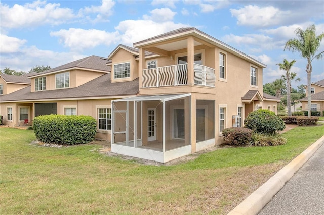 201 Dyson Dr, Deland, FL 32724 - rear view of property featuring stucco siding, a balcony, a sunroom, a yard, and a shingled roof