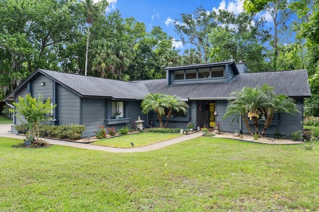 96 Hollow Branch Xing, Ormond Beach, FL 32174 - mid-century modern home featuring a shingled roof, a front yard, and a chimney