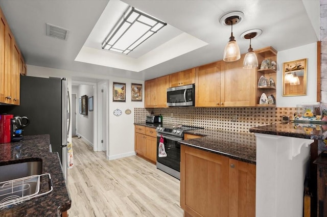96 Hollow Branch Xing, Ormond Beach, FL 32174 - kitchen with stainless steel appliances, a tray ceiling, tasteful backsplash, and dark stone counters