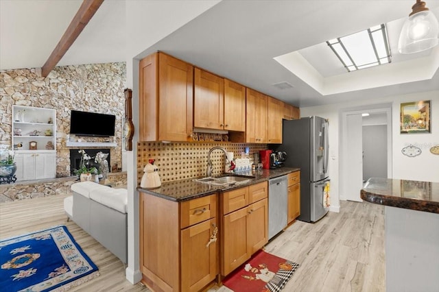 96 Hollow Branch Xing, Ormond Beach, FL 32174 - kitchen featuring a sink, appliances with stainless steel finishes, light wood finished floors, a skylight, and dark stone countertops