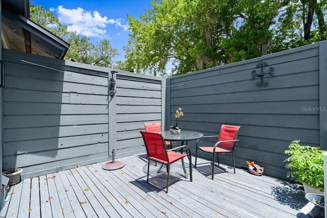 96 Hollow Branch Xing, Ormond Beach, FL 32174 - wooden terrace with outdoor dining space