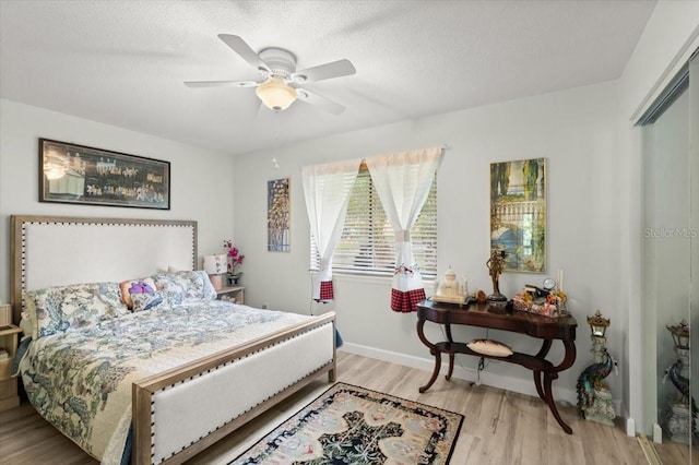 96 Hollow Branch Xing, Ormond Beach, FL 32174 - bedroom featuring light wood-type flooring, a ceiling fan, and a textured ceiling