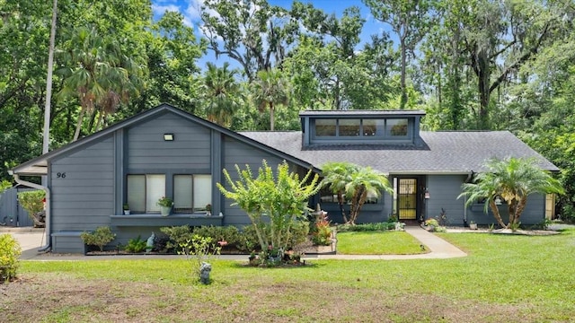 96 Hollow Branch Xing, Ormond Beach, FL 32174 - mid-century modern home with a front lawn and roof with shingles