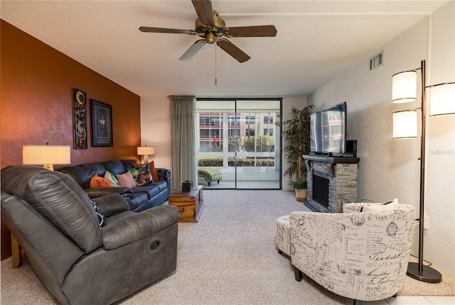 325 Wilder Blvd Unit A102, Daytona Beach, FL 32114 - carpeted living area featuring ceiling fan, a fireplace, and expansive windows