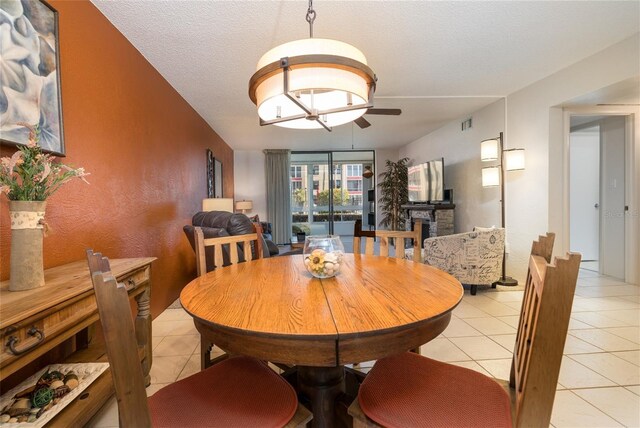 325 Wilder Blvd Unit A102, Daytona Beach, FL 32114 - dining room featuring light tile patterned floors, ceiling fan, and a textured ceiling
