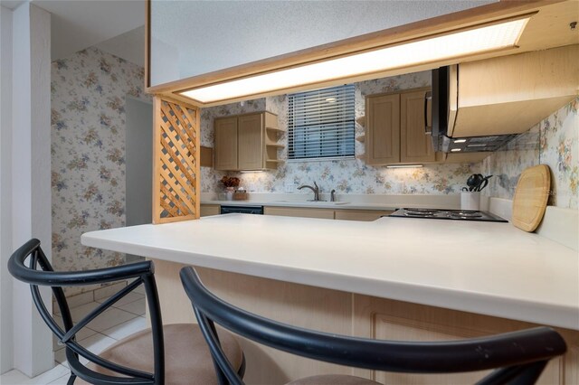 325 Wilder Blvd Unit A102, Daytona Beach, FL 32114 - kitchen featuring a sink, a kitchen breakfast bar, stovetop, a peninsula, and wallpapered walls
