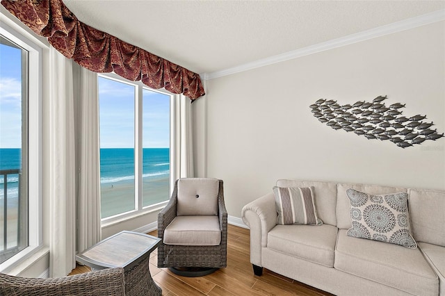 2901 S Atlantic Ave Unit 401, Daytona Beach Shores, FL 32118 - living room with crown molding, a water view, wood finished floors, and baseboards