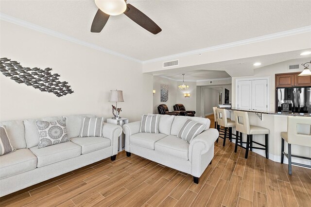2901 S Atlantic Ave Unit 401, Daytona Beach Shores, FL 32118 - living room featuring light wood-style floors, a ceiling fan, crown molding, and recessed lighting