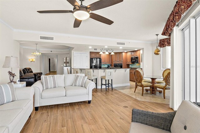 2901 S Atlantic Ave Unit 401, Daytona Beach Shores, FL 32118 - living room featuring crown molding, wood tiled floors, and a ceiling fan