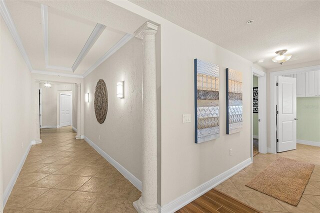 2901 S Atlantic Ave Unit 401, Daytona Beach Shores, FL 32118 - hallway featuring crown molding, baseboards, light tile patterned flooring, and a textured ceiling