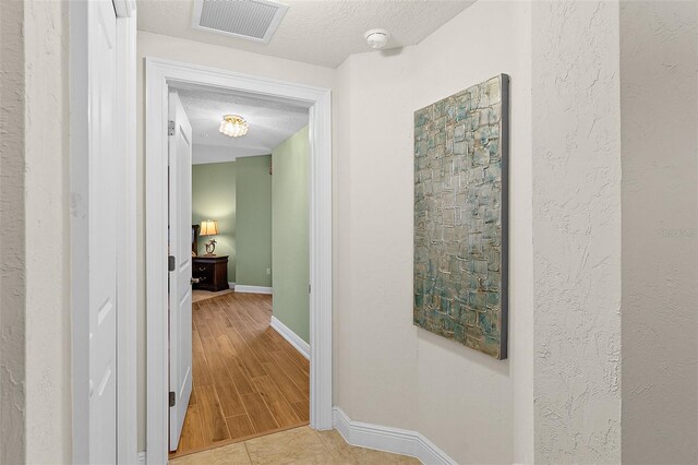 2901 S Atlantic Ave Unit 401, Daytona Beach Shores, FL 32118 - hallway featuring baseboards and a textured ceiling