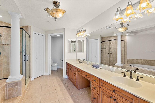 2901 S Atlantic Ave Unit 401, Daytona Beach Shores, FL 32118 - bathroom featuring ornate columns, a shower stall, tile patterned flooring, toilet, and a garden tub
