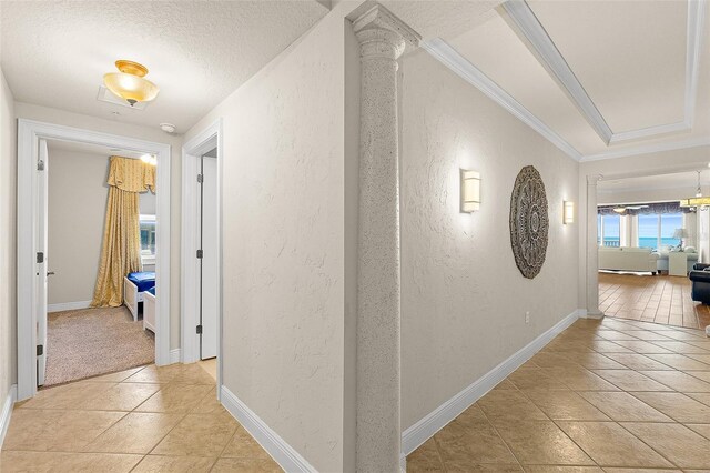 2901 S Atlantic Ave Unit 401, Daytona Beach Shores, FL 32118 - corridor featuring a textured wall, light tile patterned floors, baseboards, a textured ceiling, and ornamental molding