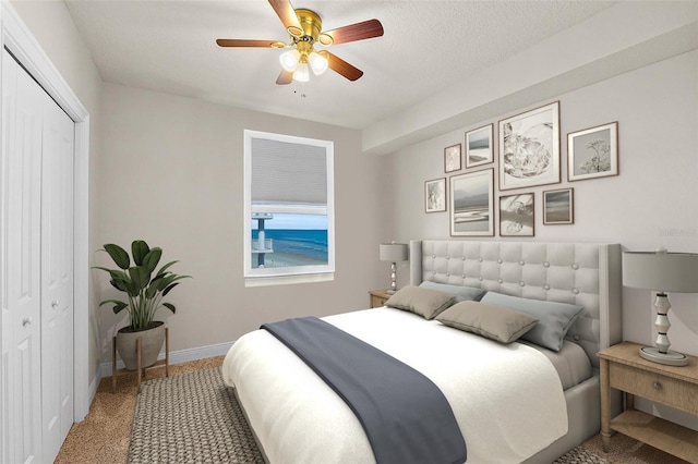 2901 S Atlantic Ave Unit 401, Daytona Beach Shores, FL 32118 - bedroom featuring a closet, baseboards, carpet floors, and ceiling fan