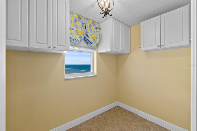 2901 S Atlantic Ave Unit 401, Daytona Beach Shores, FL 32118 - washroom featuring baseboards, tile patterned floors, and a textured ceiling