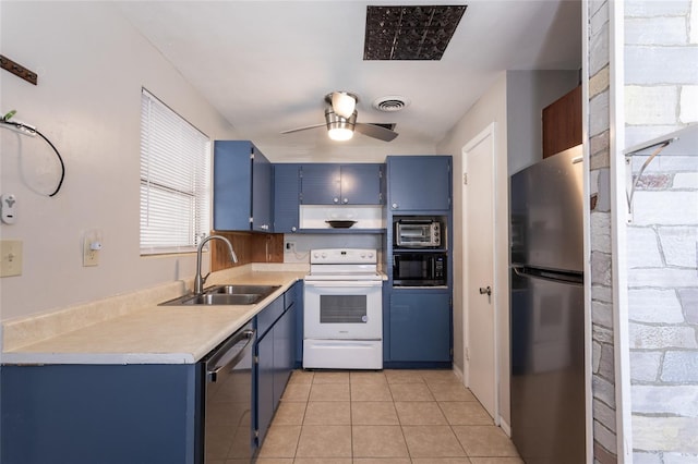 1284 Vanderbilt Dr, Ormond Beach, FL 32174 - kitchen with appliances with stainless steel finishes, blue cabinetry, a sink, light countertops, and light tile patterned flooring