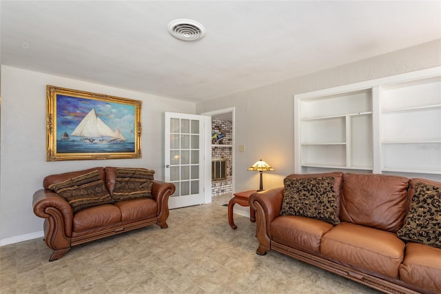 1284 Vanderbilt Dr, Ormond Beach, FL 32174 - living room featuring light floors, built in shelves, and baseboards