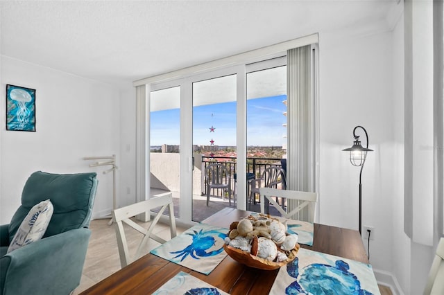 2987 S Atlantic Unit 606, Daytona Beach Shores, FL 32118 - dining space featuring a wall of windows, baseboards, and a textured ceiling