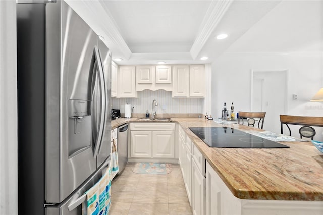 2987 S Atlantic Unit 606, Daytona Beach Shores, FL 32118 - kitchen featuring stainless steel appliances, a sink, a tray ceiling, recessed lighting, and white cabinets