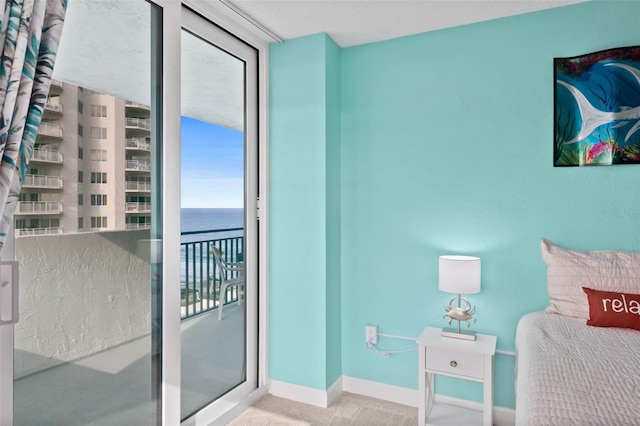 2987 S Atlantic Unit 606, Daytona Beach Shores, FL 32118 - carpeted bedroom with baseboards and a water view