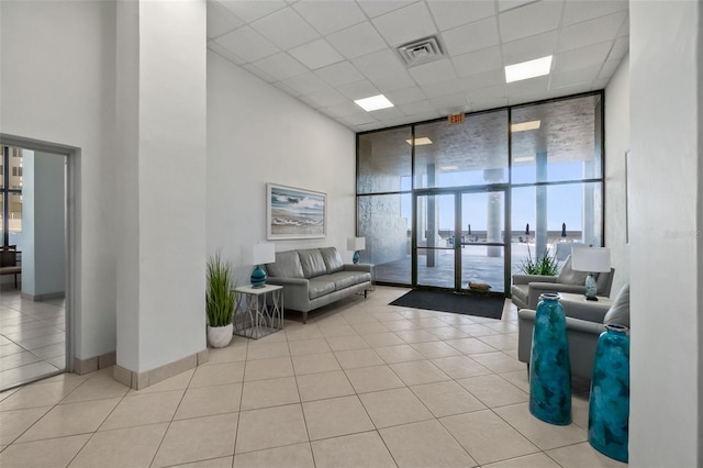 2987 S Atlantic Unit 606, Daytona Beach Shores, FL 32118 - building lobby with a wall of windows, a high ceiling, and a drop ceiling