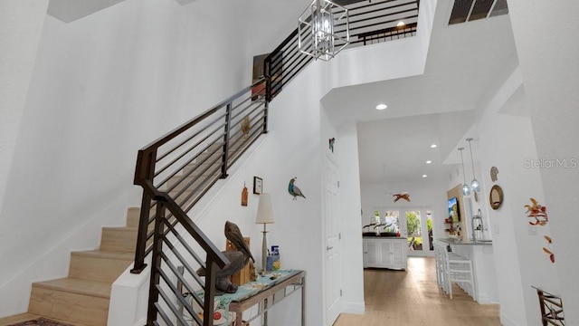 302 Tammie Sue Ln, Deland, FL 32724 - stairway featuring a high ceiling, recessed lighting, wood finished floors, and baseboards