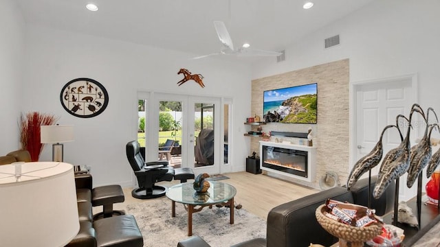 302 Tammie Sue Ln, Deland, FL 32724 - living area with wood finished floors, recessed lighting, a glass covered fireplace, a ceiling fan, and a towering ceiling