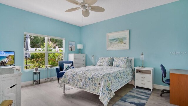 302 Tammie Sue Ln, Deland, FL 32724 - bedroom featuring baseboards, wood finished floors, a desk, and a ceiling fan