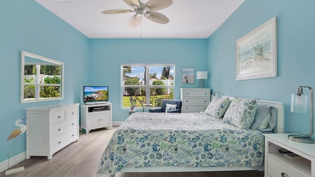 302 Tammie Sue Ln, Deland, FL 32724 - bedroom with baseboards, light wood-style flooring, and a ceiling fan