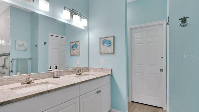 302 Tammie Sue Ln, Deland, FL 32724 - bathroom with double vanity, wood finished floors, a shower stall, and baseboards