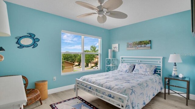 302 Tammie Sue Ln, Deland, FL 32724 - bedroom featuring wood finished floors, baseboards, and a ceiling fan