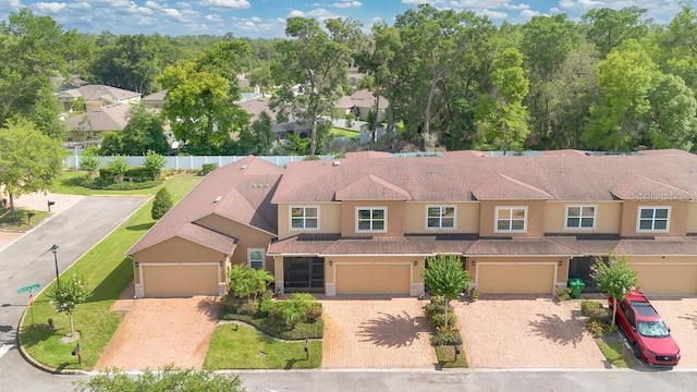 302 Tammie Sue Ln, Deland, FL 32724 - view of front of property featuring driveway, stucco siding, and a garage