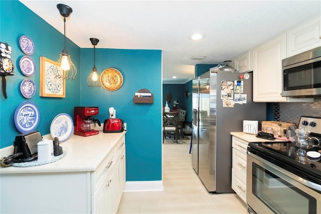 625 N Halifax Ave Unit 11, Daytona Beach, FL 32118 - kitchen featuring stainless steel appliances, light countertops, tasteful backsplash, decorative light fixtures, and recessed lighting