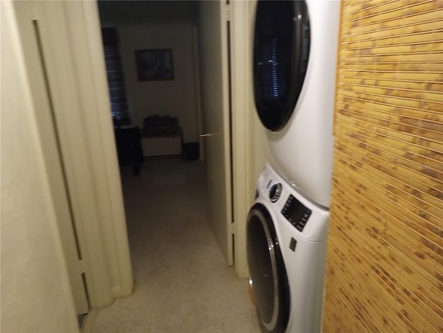 1640 Juno Trl Unit 103F, Astor, FL 32102 - washroom featuring stacked washing machine and dryer and wood walls