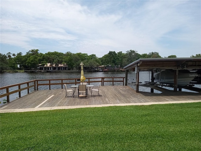 1640 Juno Trl Unit 103F, Astor, FL 32102 - dock area featuring boat lift, a water view, and a lawn