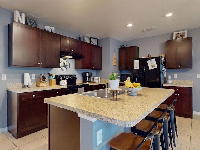 2919 Sime St, New Smyrna Beach, FL 32168 - kitchen featuring black appliances, a sink, under cabinet range hood, light tile patterned floors, and a breakfast bar