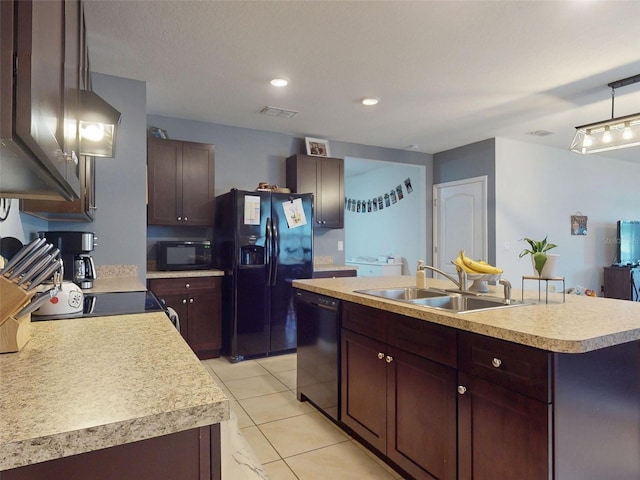 2919 Sime St, New Smyrna Beach, FL 32168 - kitchen with black appliances, a sink, light countertops, an island with sink, and light tile patterned flooring