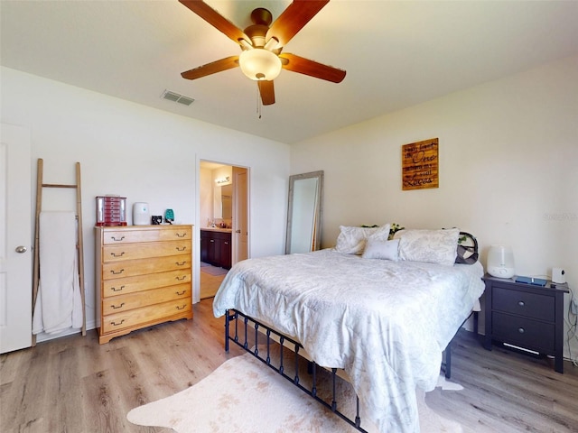 2919 Sime St, New Smyrna Beach, FL 32168 - bedroom with wood finished floors, a ceiling fan, and ensuite bathroom
