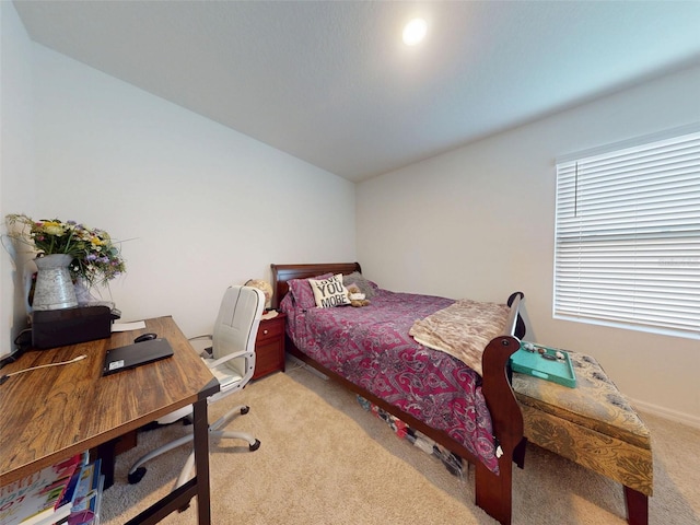 2919 Sime St, New Smyrna Beach, FL 32168 - bedroom featuring light colored carpet, vaulted ceiling, a desk, and baseboards