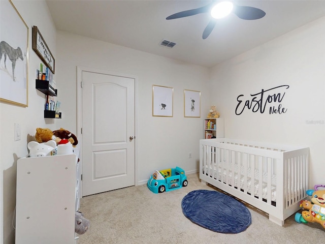 2919 Sime St, New Smyrna Beach, FL 32168 - carpeted bedroom featuring a nursery area, a ceiling fan, and baseboards